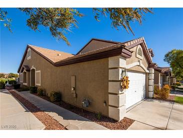 Charming single-story home with a well-maintained lawn, walkway, and attached two-car garage at 10336 Birch Bluff Ln, Las Vegas, NV 89145