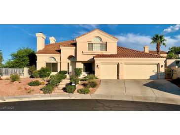 Charming two-story home featuring a tile roof, desert landscaping, and a spacious two-car garage at 1915 Hazeltine Ct, Henderson, NV 89074