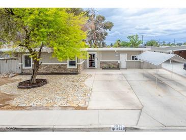 Charming single-story home features stone accents, mature landscaping, and a covered parking area at 2819 Taylor Ave, North Las Vegas, NV 89030