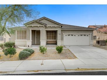 Charming single-story home featuring a well-maintained front yard and a two-car garage at 5833 Craigmore Ln, North Las Vegas, NV 89031