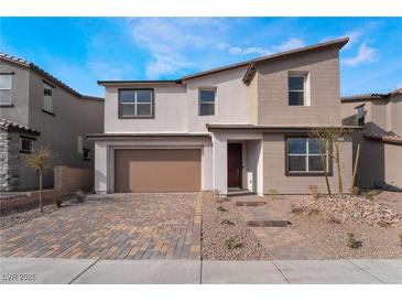 Two-story home with a neutral color palette, attached two-car garage and a charming brick paved driveway at 785 Black Palace St, Henderson, NV 89011
