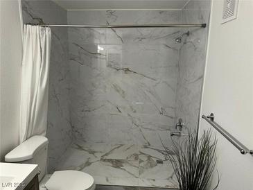 Modern bathroom featuring stylish marble-look tile in the shower at 7885 W Flamingo Rd # 2019, Las Vegas, NV 89147
