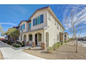 Charming two-story townhome with a covered porch and desert landscaping at 8562 Insignia Ave # 102, Las Vegas, NV 89178