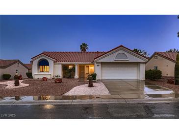 Charming single-story home boasts a red tile roof, two-car garage, and desert landscaping at 8613 Linderwood Dr, Las Vegas, NV 89134