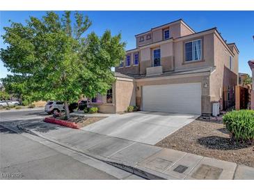 Two-story home with tan stucco, three-car garage, and mature shade tree in front yard at 9065 W Torino Ave, Las Vegas, NV 89148