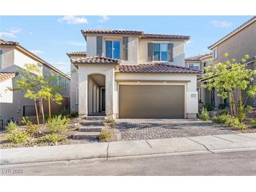Two story home featuring neutral colored exterior, red tile roof, and two car garage at 10851 Hanwicke Harbor Ave, Las Vegas, NV 89166
