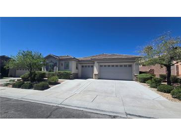 Attractive single-story home with a three-car garage and well-maintained landscaping at 11621 La Mirago Pl, Las Vegas, NV 89138