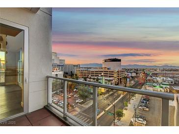 Enjoy panoramic city views from the balcony with glass railings at dusk at 150 N Las Vegas Blvd # 804, Las Vegas, NV 89101