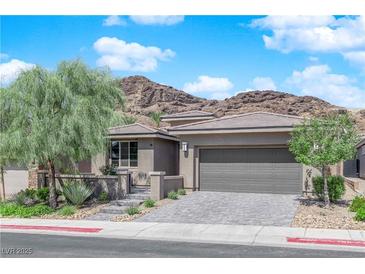 Charming single-story home with a two-car garage, neat landscaping, and a picturesque mountain backdrop at 40 Vicolo Della Luna, Henderson, NV 89011