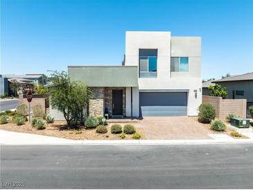 Contemporary two-story home with a well-manicured xeriscaped front yard and a two car garage at 4246 W Landberg Ave, Las Vegas, NV 89141