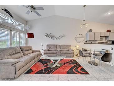 Spacious living room with vaulted ceilings, modern decor, and an open concept design at 5171 Briar Patch Way, Las Vegas, NV 89118