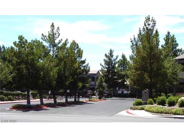 Gated community entrance with mature trees and manicured landscaping adding to the property's curb appeal at 555 E Silverado Ranch Blvd # 2147, Las Vegas, NV 89183