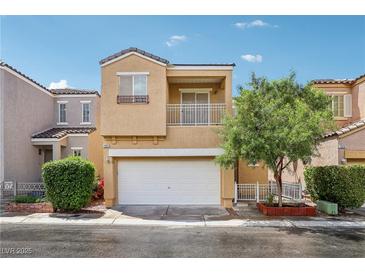 Inviting two-story home featuring a balcony, a two-car garage, and charming landscaping at 7331 Carrot Ridge St, Las Vegas, NV 89139