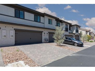 Charming townhomes featuring private garages and modern architecture at 835 Jigglypuff Pl, Henderson, NV 89011
