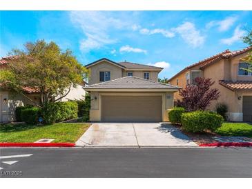 Charming two-story home featuring well-maintained landscaping, a two-car garage, and a welcoming entrance at 9360 Canalino Dr, Las Vegas, NV 89134