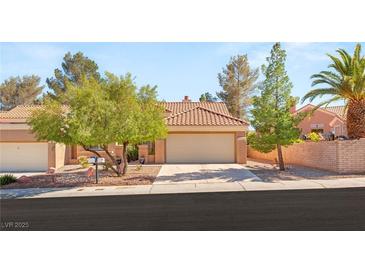 Charming single-story home featuring a well-manicured yard and two-car garage at 9445 January Dr, Las Vegas, NV 89134