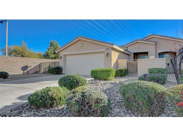 Charming single story home featuring a two-car garage, gated entry, desert landscaping, and neutral color palette at 10201 Premia Pl, Las Vegas, NV 89135
