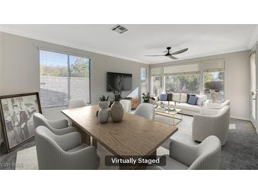 Bright, airy living and dining room featuring modern furnishings, large windows, and neutral tones at 10201 Premia Pl, Las Vegas, NV 89135