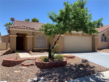 Charming single-story home features a tile roof, manicured landscaping, and a two-car garage at 1712 Matador Way, Las Vegas, NV 89128