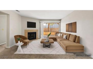 Comfortable living room features a fireplace, contemporary furnishings and opens to the outside deck at 2200 S Fort Apache Rd # 1033, Las Vegas, NV 89117