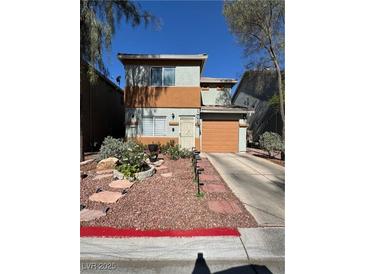 Charming two-story home featuring a well-manicured front yard and an attached one car garage at 2229 Steele St, Las Vegas, NV 89156