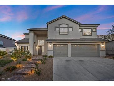Charming two-story home with a landscaped yard and a three-car garage at 2647 Hourglass Dr, Henderson, NV 89052