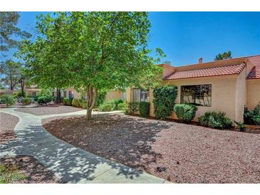 Inviting home exterior with a paved walkway, mature trees, and well-maintained landscaping at 2851 S Valley View Blvd # 1196, Las Vegas, NV 89102