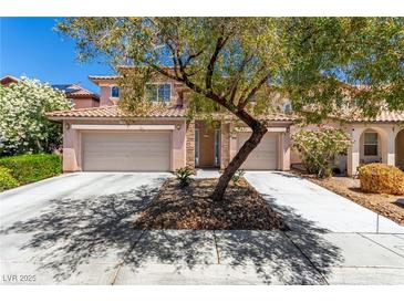 Charming two-story home featuring a tile roof, stone accents, and a two-car garage at 3408 Livia Ave, North Las Vegas, NV 89031