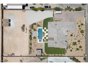 Expansive property featuring a large pool, patio, and extensive landscaping, all enclosed within a secure perimeter fence at 3955 W Jo Rae Ave, Las Vegas, NV 89141
