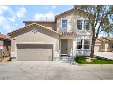 Charming stucco two-story home with a two car garage and a well kept yard at 529 Fork Mesa Ct, Henderson, NV 89015