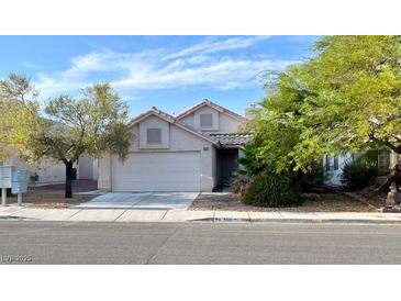 Charming single-story home with a well-maintained lawn and an attached two-car garage at 5512 Del Lago Dr, Las Vegas, NV 89130