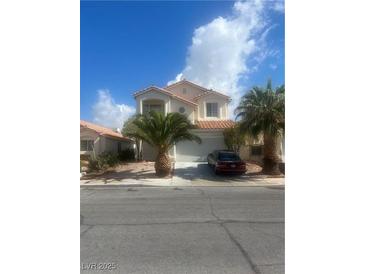 Two-story home with desert landscaping, garage, and a red tile roof on a sunny day at 7228 Chic Ave, Las Vegas, NV 89129