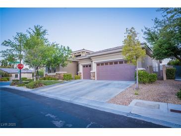 Beautiful single story home with desert landscaping, two car garage, and neutral color palette at 10391 Avebury Manor Ln, Las Vegas, NV 89135