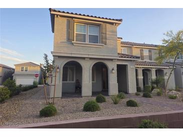 Charming two-story home featuring arched entryways and desert landscaping at 1145 Belton Lake Ave, North Las Vegas, NV 89086
