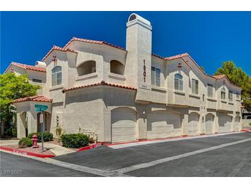Charming townhome with private garages, red tile roof, and stucco facade on a sunny day at 1501 Oscar Ct # 101, Las Vegas, NV 89146