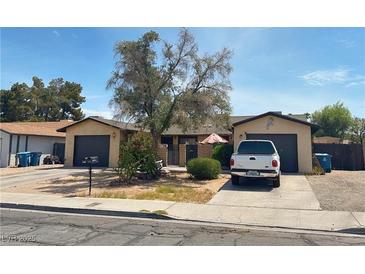Charming single-story home featuring a well-maintained front yard and a private driveway at 1569 Hialeah Dr, Las Vegas, NV 89119
