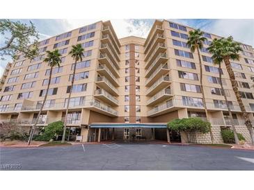 A bright, multi-story condo building with palm trees and a covered entry at 205 E Harmon Ave # 112, Las Vegas, NV 89169