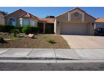 Charming single-story home with a well-maintained front yard and attached two-car garage at 2874 Tori Way, Henderson, NV 89074