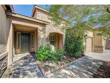 Charming single-story home with a stone facade, well-kept landscaping, and a welcoming front entrance at 4260 Helena Cove Ct, Las Vegas, NV 89129