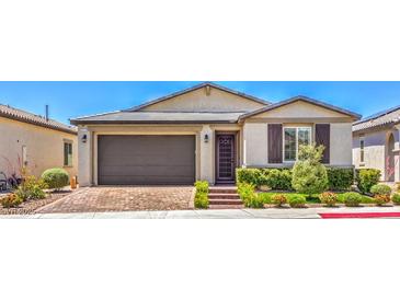 Charming single-story home with a well-maintained front yard and brick paved driveway at 5429 Blinding Lights St, North Las Vegas, NV 89081