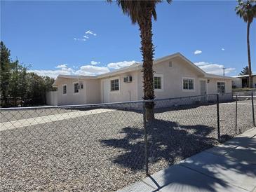Charming single-story home with stucco siding, a desert landscape, and a chain link fence at 629 N 16Th St, Las Vegas, NV 89101
