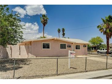Charming single-story home with desert landscaping, fenced yard, and mature palm trees at 629 N 16Th St, Las Vegas, NV 89101