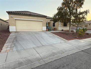 Charming single-story home featuring a two-car garage, desert landscaping, and a welcoming front porch at 6617 Johnny Love Ln, North Las Vegas, NV 89086