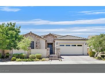 Charming single-story home with stone accents, a tile roof, and a well-manicured front yard at 8405 Canyon Crevasse St, Las Vegas, NV 89166