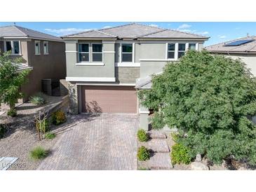 Charming two-story home featuring a well-maintained yard and a brick-paved driveway leading to a two-car garage at 888 Cherry Glen Pl, Las Vegas, NV 89138