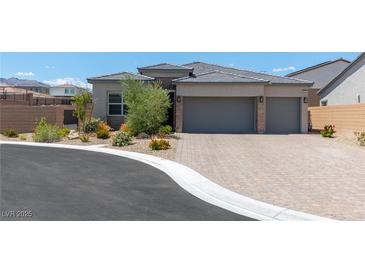 Beautiful single-story home with a two-car garage and a well-manicured front yard at 8929 Cassia Winds St, Las Vegas, NV 89166