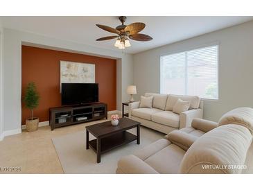 Bright living room features neutral walls, tile floors, and a ceiling fan at 9780 Ziegler Ave, Las Vegas, NV 89148