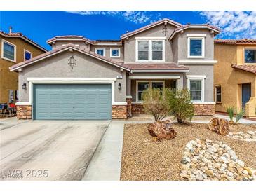 Charming two-story home with a two-car garage and desert landscaping with a beautiful, natural rock feature at 140 Rolling Cove Ave, Henderson, NV 89011