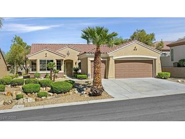 Charming single-story home featuring a well-manicured yard, desert landscaping, and a two-car garage at 2110 Fort Sanders St, Henderson, NV 89052