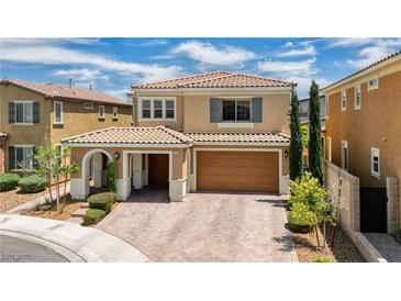 Charming two-story home featuring a tile roof, porte-cochere, and manicured landscaping at 2154 Tortona St, Henderson, NV 89044